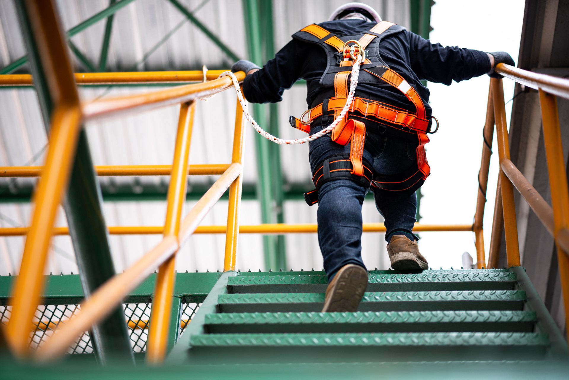 Construction worker wearing safety harness